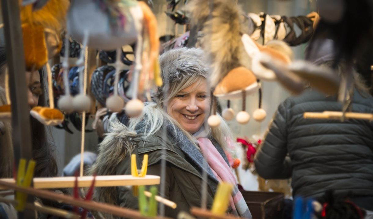 A women looks at the toys on a stall at Greenwich Market